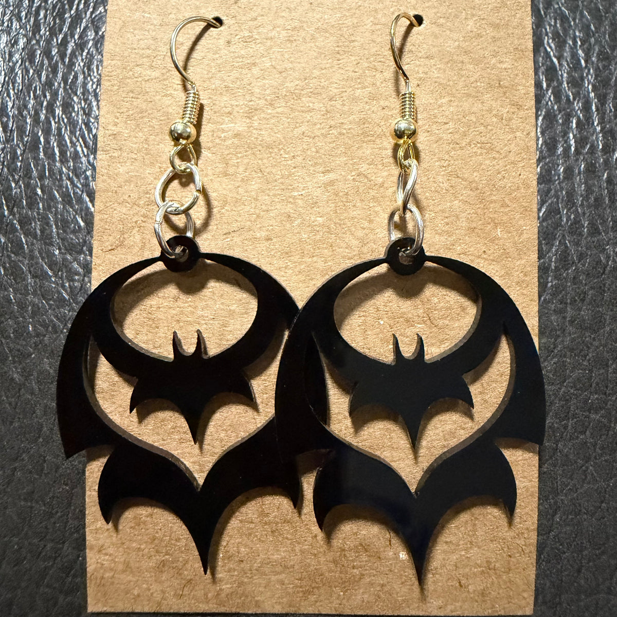 Small bat Halloween earrings displayed as a pair