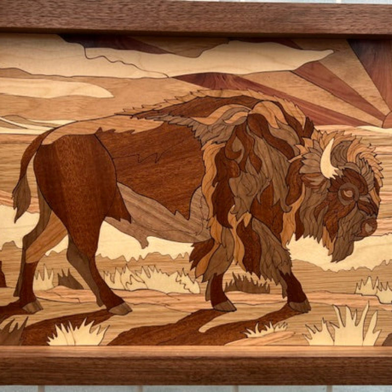 Wooden inlay artwork of a bison in a landscape