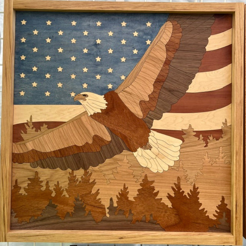 Wooden artwork of an eagle with an American flag background