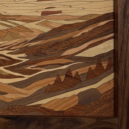 Close-up of the corner of the Rolling Mountains wall art showing the solid walnut frame and inlaid wood layers