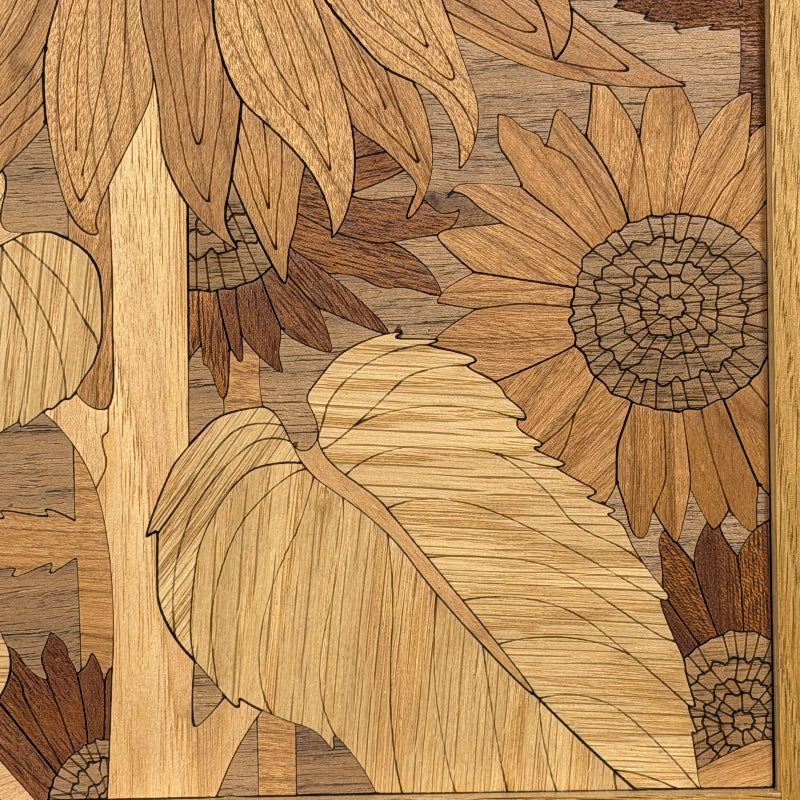 Close-up of wooden leaf details in a sunflower wall art inlay, showing natural wood grain and tone.
