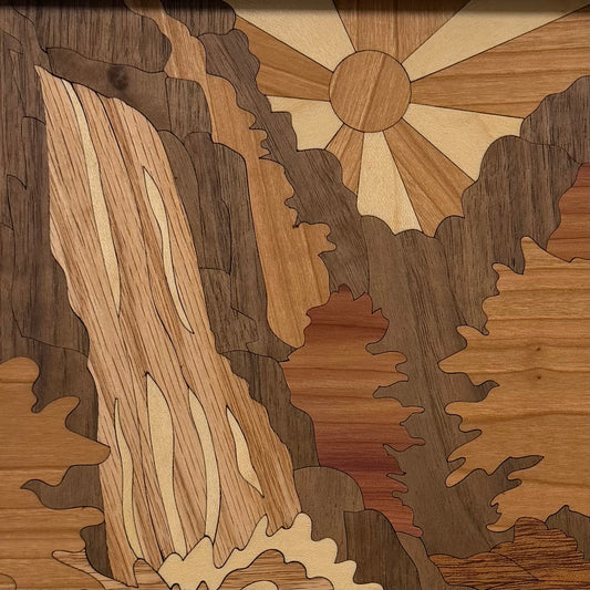 Close-up of the inlaid wood waterfall cascading over rocks on the Waterfall wall art