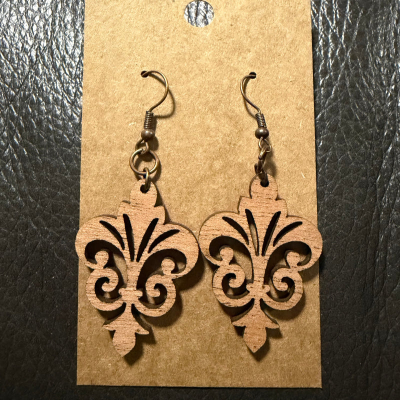 Fleur-de-lis wood earrings shown in walnut wood
