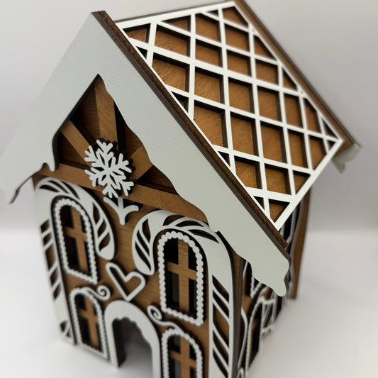 Angled view of the wooden gingerbread house roof with white frosting details