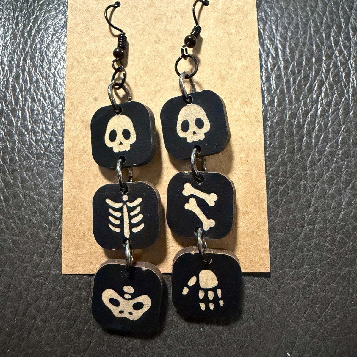 Three section skeleton Halloween earrings shown from another angle