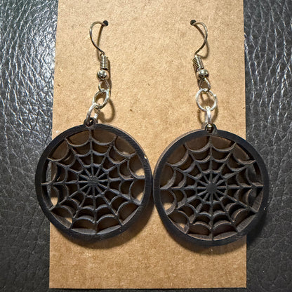 Small round cobweb Halloween earrings shown from another angle