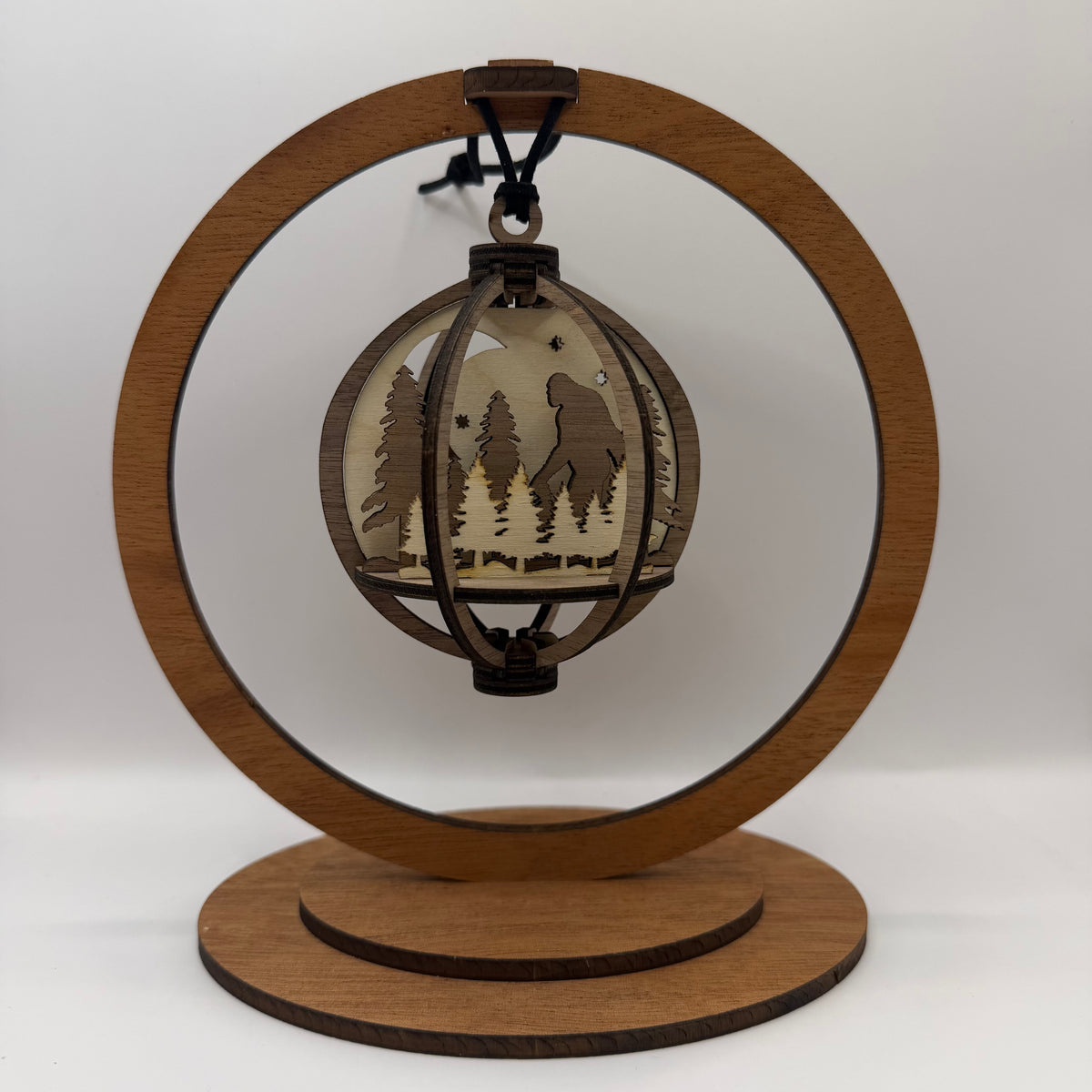 3D Bigfoot Trees wood ornament shown in a display stand