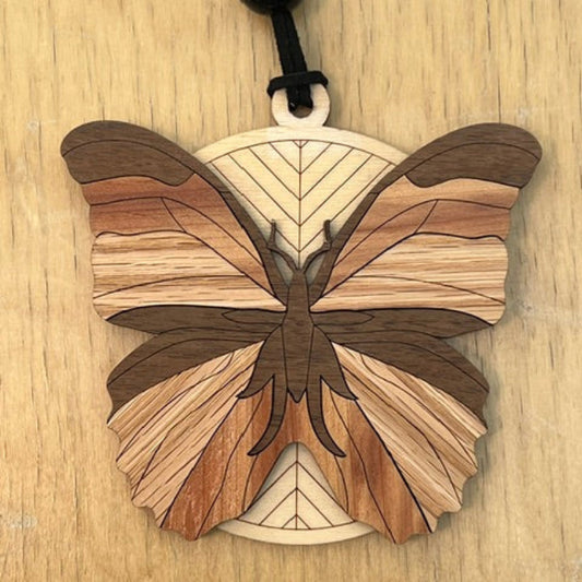 Wooden butterfly ornament on a wooden surface
