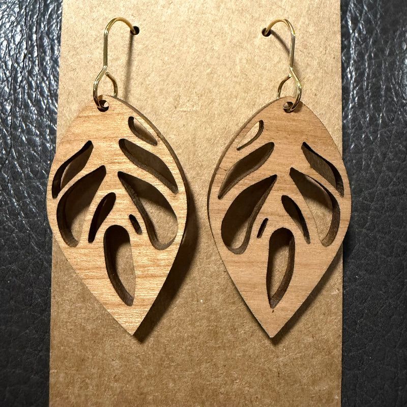 Leaf shaped wood earrings displayed as a pair