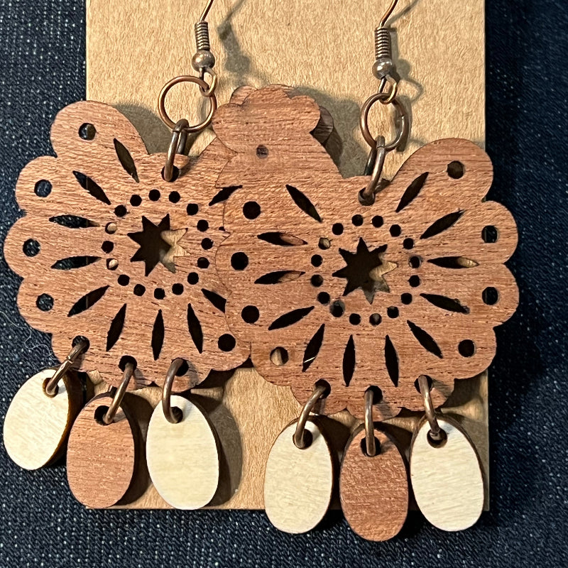 Wood dangling earrings featuring a chicken with three hanging eggs