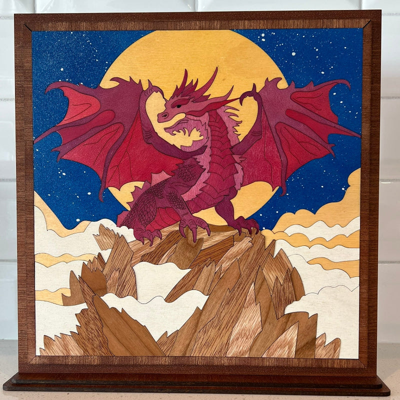 Handmade wooden wall art of a dragon perched on a mountain peak, 10.5x10.5 inches