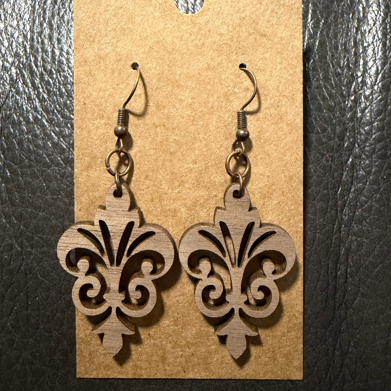 Fleur-de-lis wood earrings shown from another angle