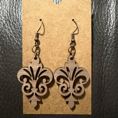Fleur-de-lis wood earrings shown from another angle