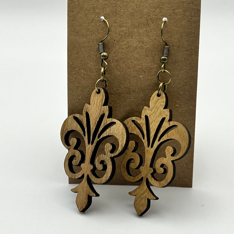 Close-up of fleur-de-lis wood earring design