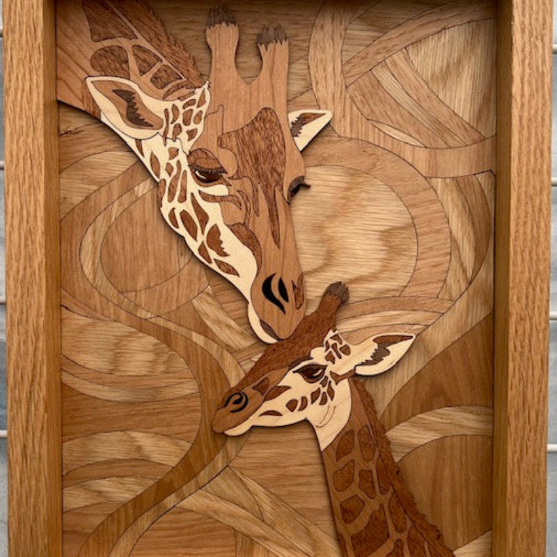 Wooden wall art with engraved giraffes in a geometric pattern