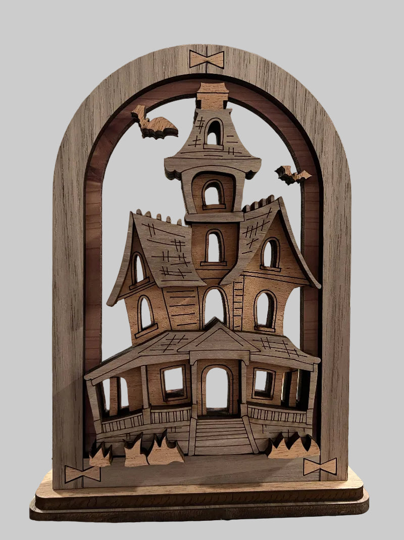 Wooden multi-layered decorative arch that sits on a shelf , desk or table, with a haunted house design