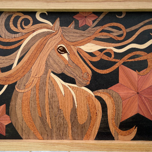 A framed wooden inlay artwork depicting a stylized horse head with flowing mane details and star-like shapes on a dark background, set in a light wood frame against a white tiled wall.