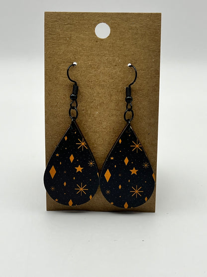 Black teardrop earrings with UV printed orange stars and shapes design