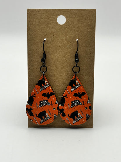 Orange teardrop earrings with UV printed black cats, bats, and moths design
