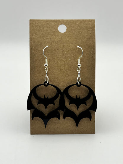 Small black acrylic bat-shaped earrings