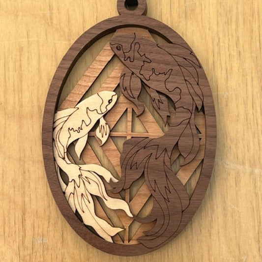 Wooden decorative item with koi fish laser-cut designs on a wooden surface