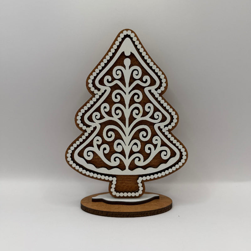 wood gingerbread tree with dark wood background and white swirly frosting overlay