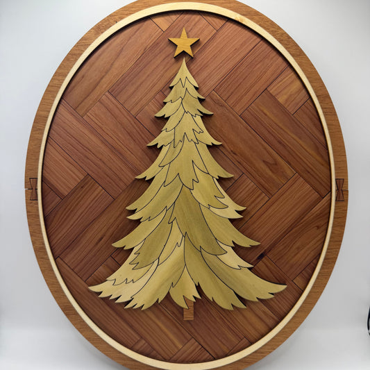 Oval wood inlay Christmas tree wall art with a green poplar tree, canary wood star, cedar herringbone background and mahogany frame