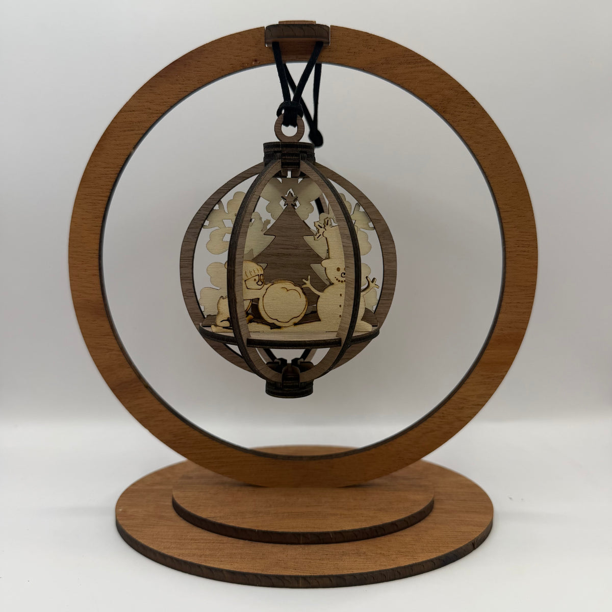 3D Snowman and Penguin wood ornament shown in a display stand