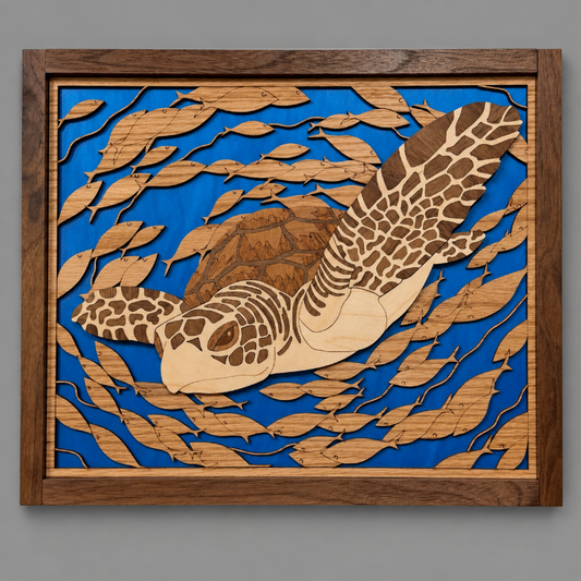 A square wooden wall art piece featuring a laser-cut sea turtle swimming among layered leaf shapes over a bright blue background, set in a medium brown wood frame against a neutral gray wall.