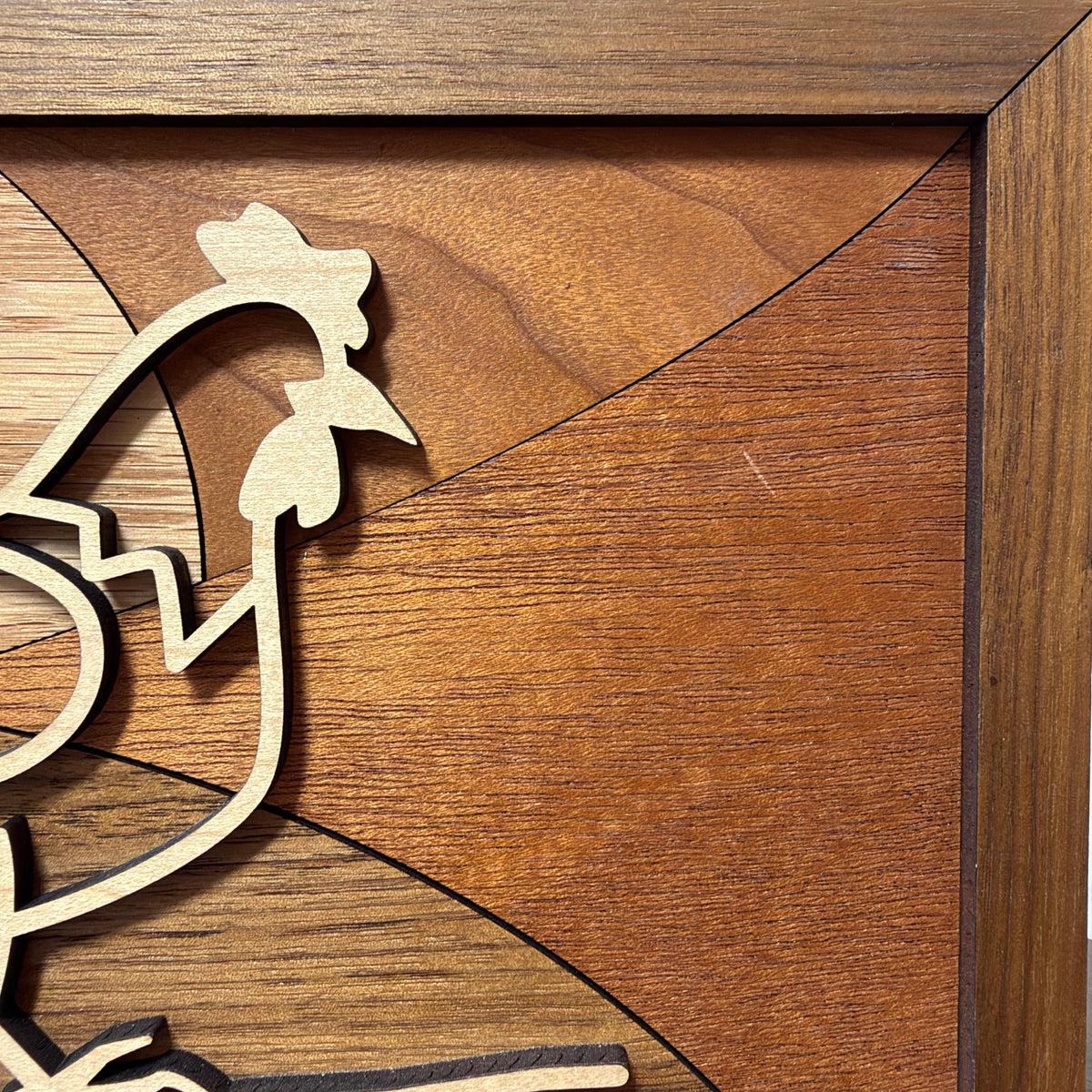Close-up of the maple hen's head and the inlaid wood grain on the chickens line art