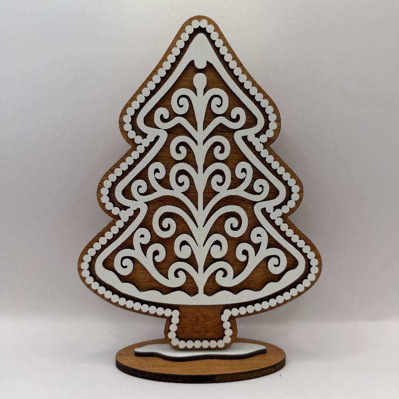 close up of wood gingerbread tree with dark wood and white frosting like overlay