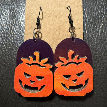 Tombstone with jack-o-lantern earrings shown from another angle