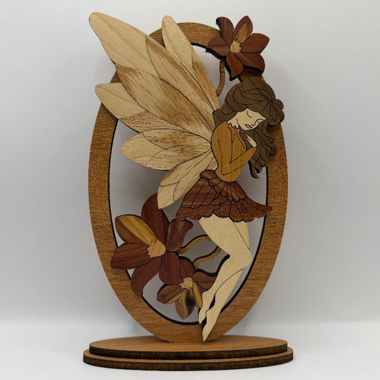 Wooden fairy shelf sitter nestled in cedar flowers, made from mahogany, cedar, red oak, maple, and walnut