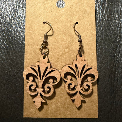 Fleur-de-lis wood earrings shown in walnut wood