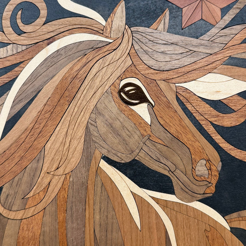 Close-up of a decorative wooden horse head artwork with layered wood inlays forming the face, mane, and dark blue background.