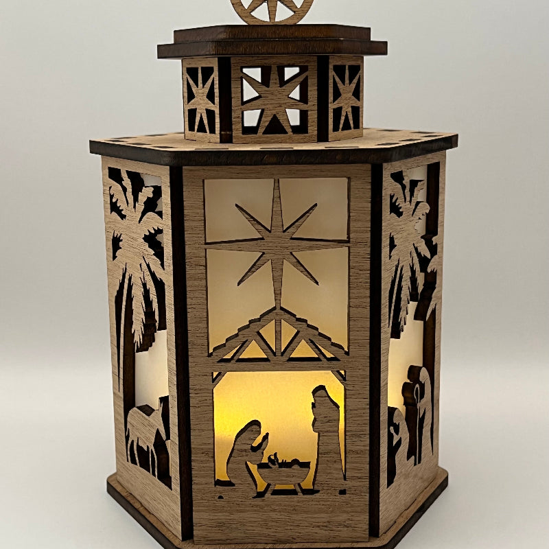 6-sided Nativity lantern lit, glowing with the battery candle inside