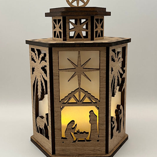 6-sided Nativity lantern lit, glowing with the battery candle inside