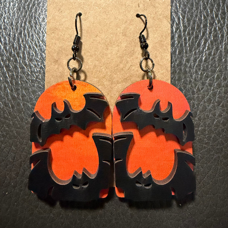 Tombstone with bats earrings shown from another angle