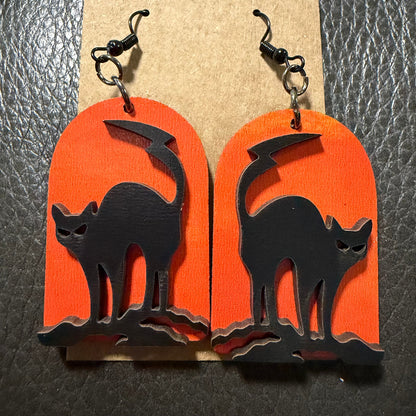 Tombstone with black cats earrings shown from another angle