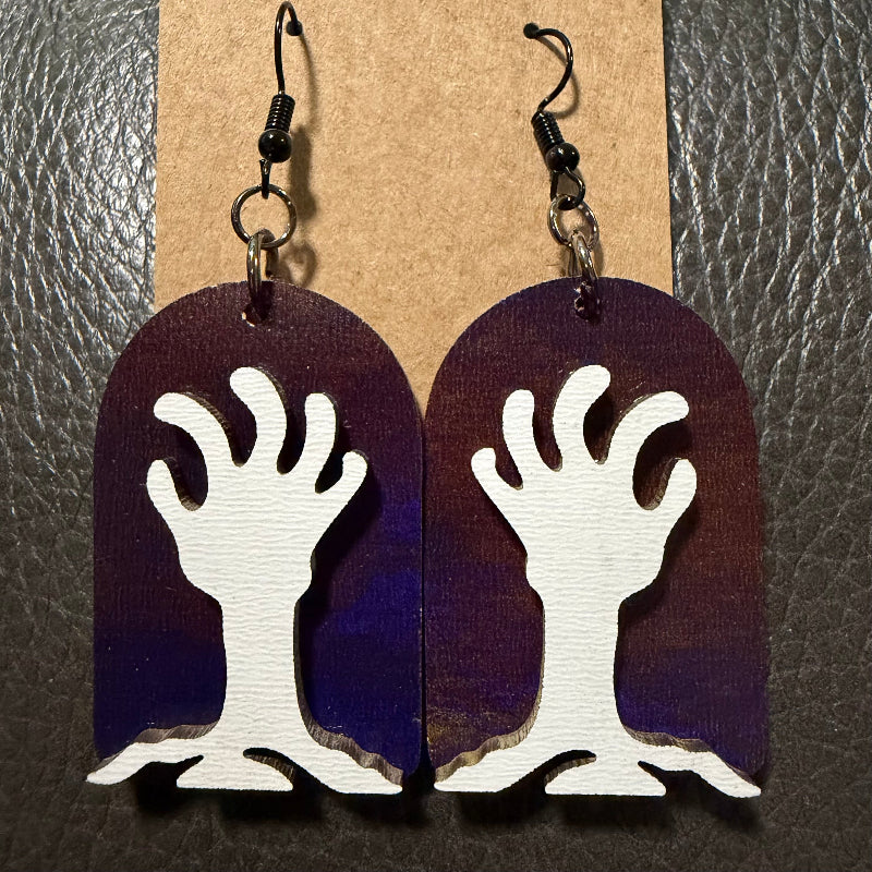 Tombstone-shaped earrings with UV-printed zombie hands bursting through