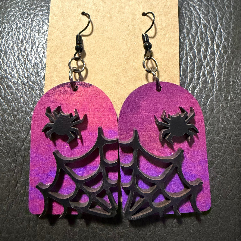 Tombstone with spiders earrings shown from another angle