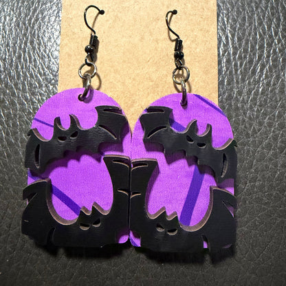 Tombstone-shaped earrings with bold black UV-printed bats
