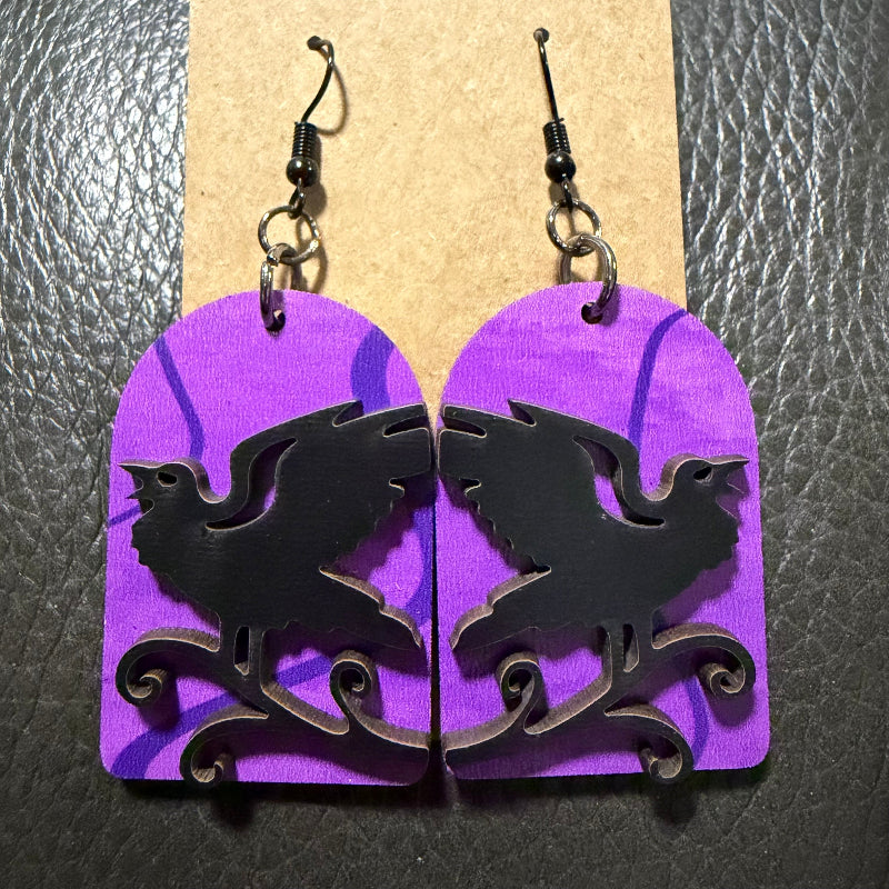 Tombstone with raven earrings shown from another angle