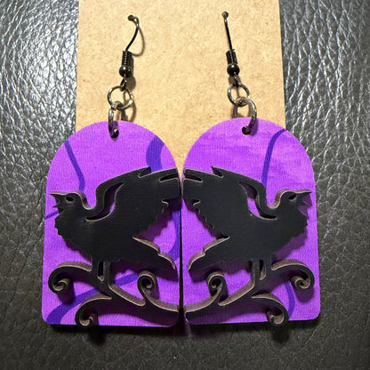 Tombstone with raven earrings shown from another angle