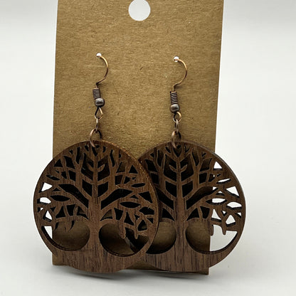 Tree of life earrings shown in walnut wood